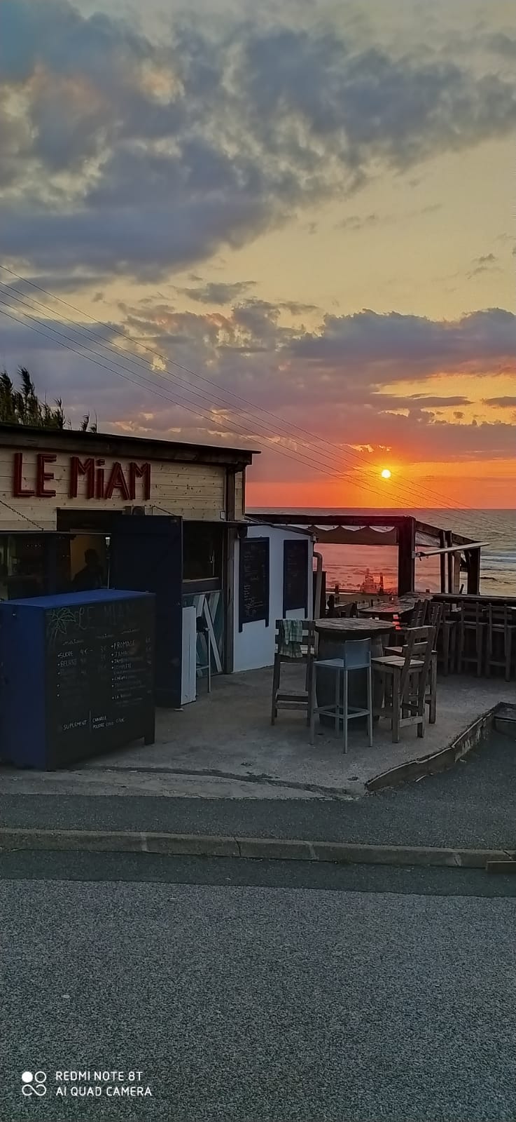 Le Miam au coucher du soleil, enseigne rouge visible, ciel embrasé sur l'Atlantique
